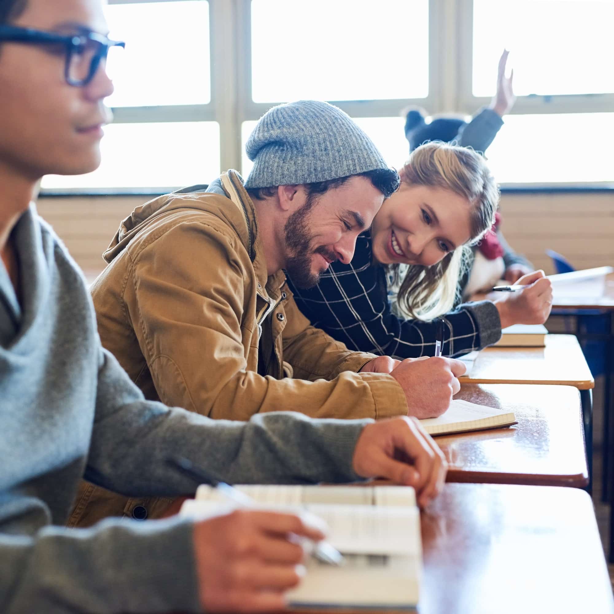 Cropped shot of a group of university students working in class while sitting in a lecture